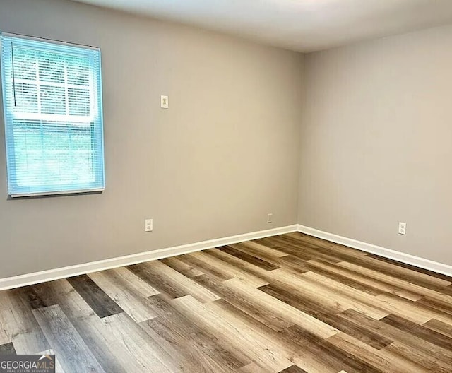 empty room with hardwood / wood-style flooring