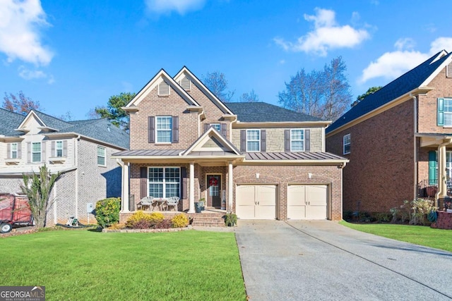 view of front of property with covered porch, a garage, and a front yard