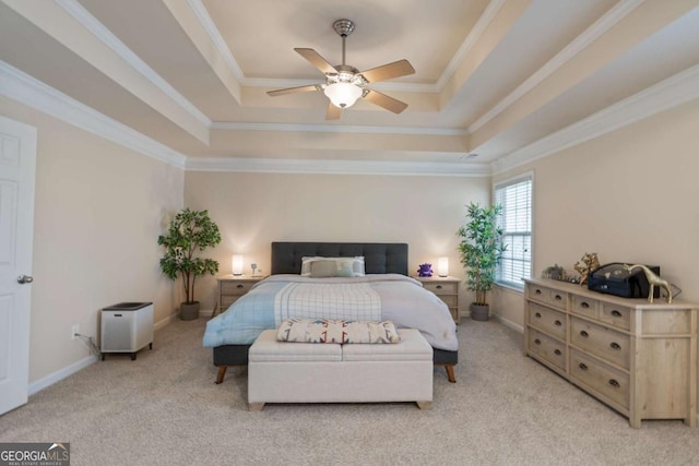 carpeted bedroom with a raised ceiling, ceiling fan, and ornamental molding