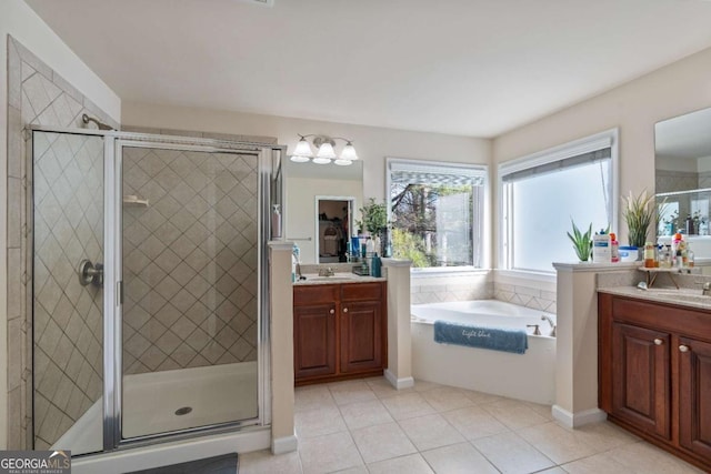 bathroom with tile patterned floors, vanity, and separate shower and tub