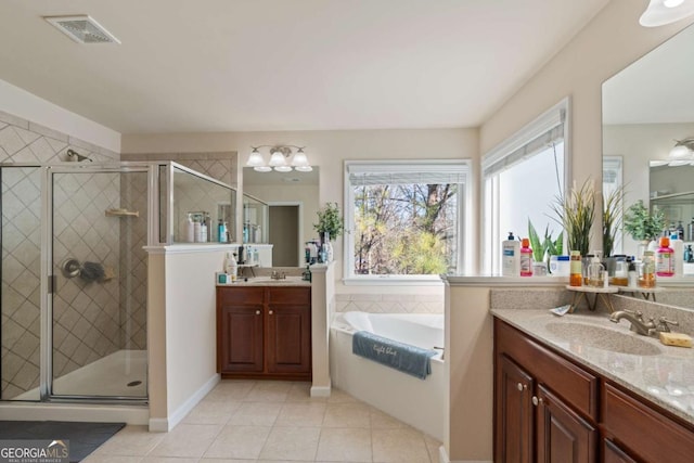 bathroom featuring tile patterned floors, separate shower and tub, and vanity