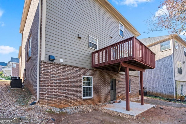 rear view of house featuring a patio, a deck, and central AC unit