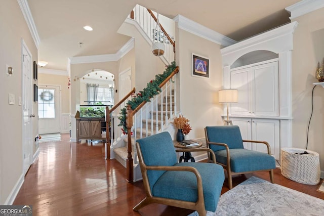 living area with dark hardwood / wood-style floors and ornamental molding