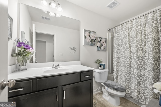 bathroom with tile patterned flooring, vanity, and toilet