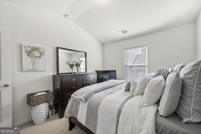 bedroom with light carpet and vaulted ceiling