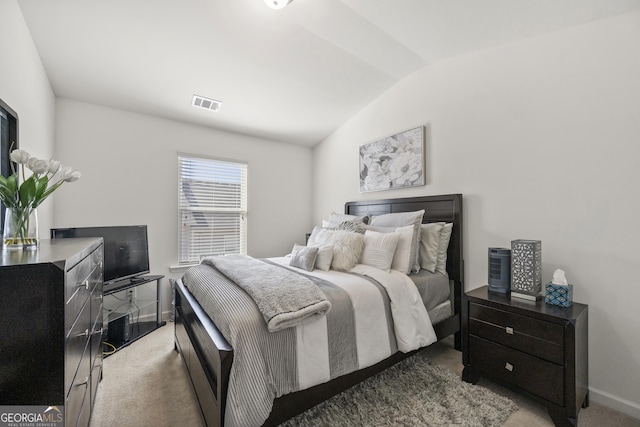 carpeted bedroom featuring lofted ceiling