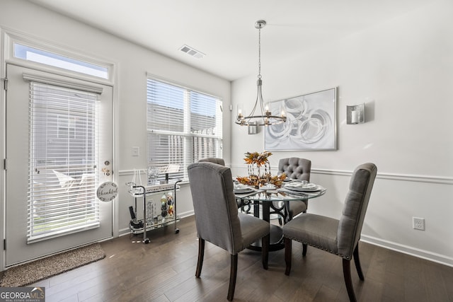 dining area with a chandelier and dark hardwood / wood-style floors