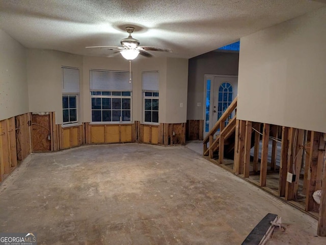 spare room with ceiling fan, a textured ceiling, and french doors