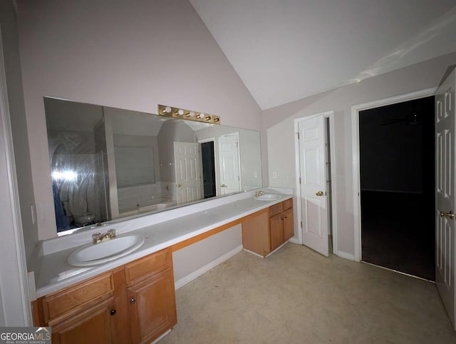 bathroom with vanity and high vaulted ceiling