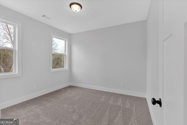 spare room featuring carpet