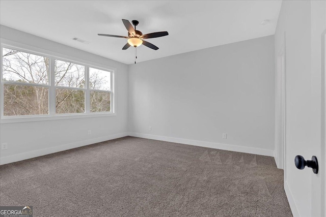 carpeted spare room with ceiling fan