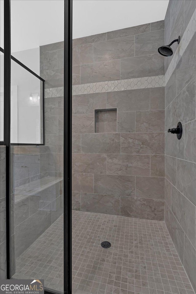 bathroom with a tile shower