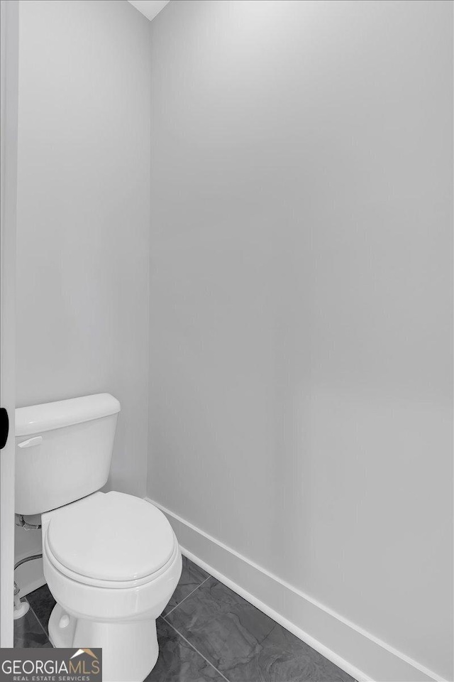 bathroom with tile patterned flooring and toilet