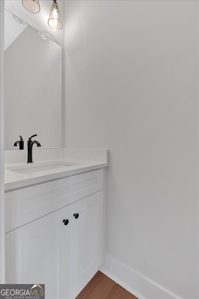 bathroom with wood-type flooring and vanity