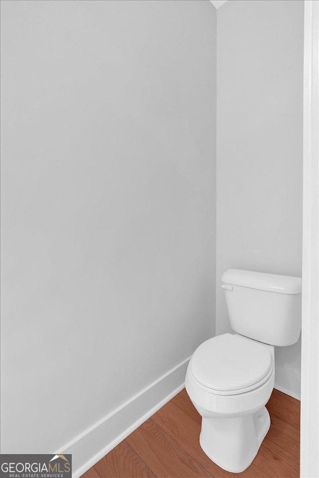 bathroom featuring hardwood / wood-style floors and toilet