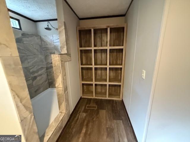 interior space with crown molding and dark wood-type flooring