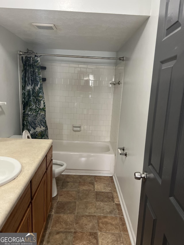 full bathroom featuring shower / bathtub combination with curtain, vanity, a textured ceiling, and toilet