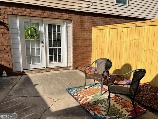 entrance to property with a patio area and french doors