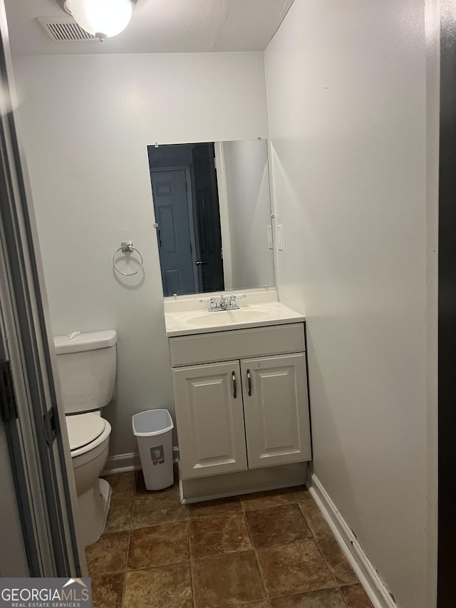 bathroom featuring vanity and toilet