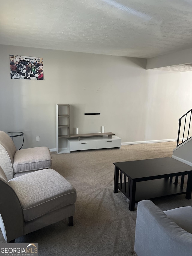 living room featuring carpet flooring and a textured ceiling