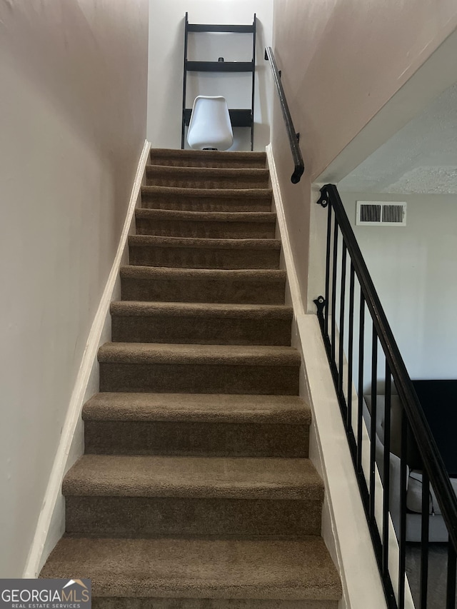 stairway with carpet floors