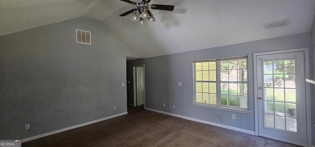 interior space featuring ceiling fan, lofted ceiling, and dark colored carpet