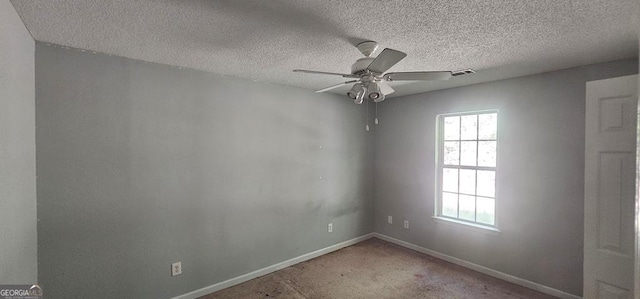 spare room with ceiling fan, carpet, and a textured ceiling