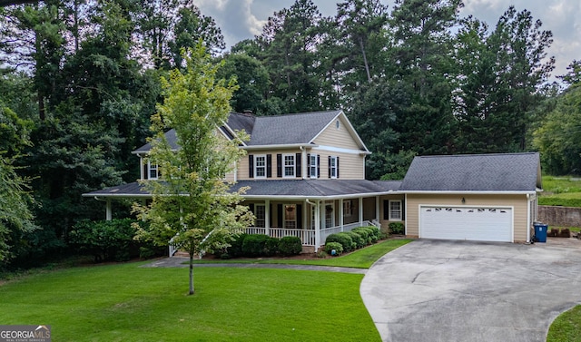 view of front facade featuring a front yard, a porch, and a garage