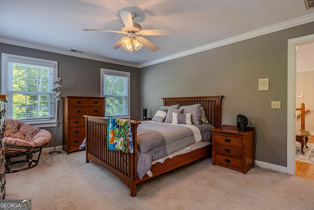 carpeted bedroom with multiple windows, ceiling fan, and ornamental molding