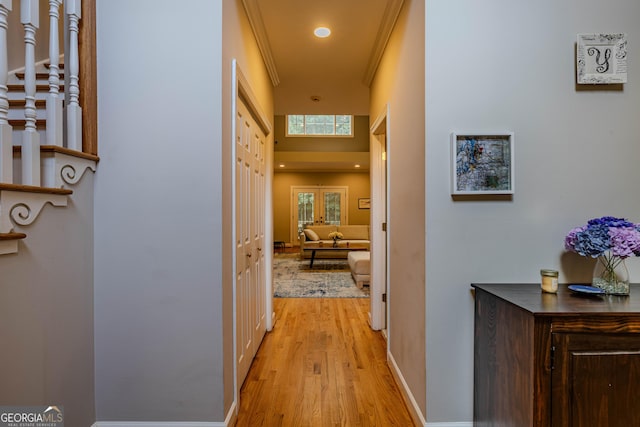 hall with crown molding and light wood-type flooring