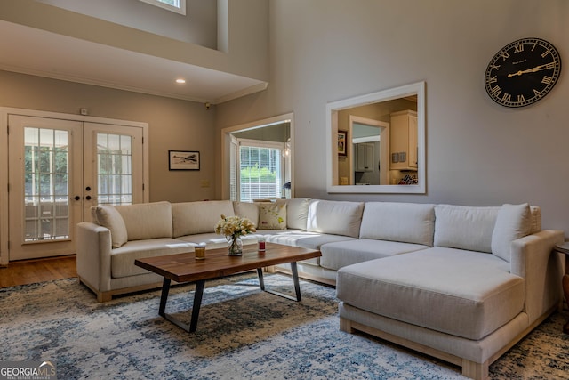 living room featuring hardwood / wood-style floors, french doors, and a high ceiling