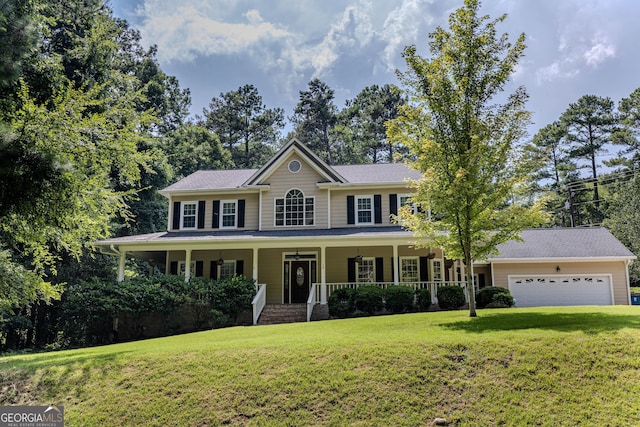 colonial home featuring covered porch, a garage, and a front lawn