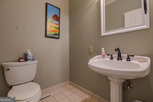 bathroom featuring toilet and tile patterned floors