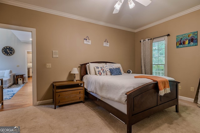 bedroom featuring light hardwood / wood-style flooring, ceiling fan, and ornamental molding