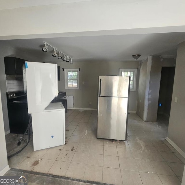 kitchen with decorative backsplash and stainless steel refrigerator