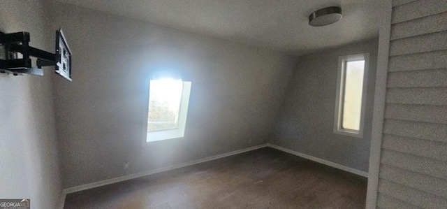 unfurnished room with dark wood-type flooring