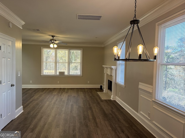 unfurnished living room featuring dark hardwood / wood-style floors, crown molding, and ceiling fan with notable chandelier