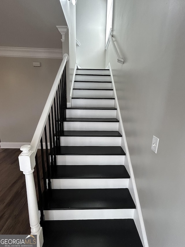 stairway featuring hardwood / wood-style flooring and crown molding