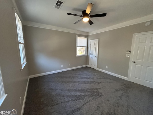 carpeted spare room featuring ceiling fan and ornamental molding