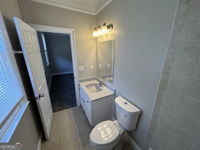 bathroom with toilet, vanity, tile patterned floors, and ornamental molding