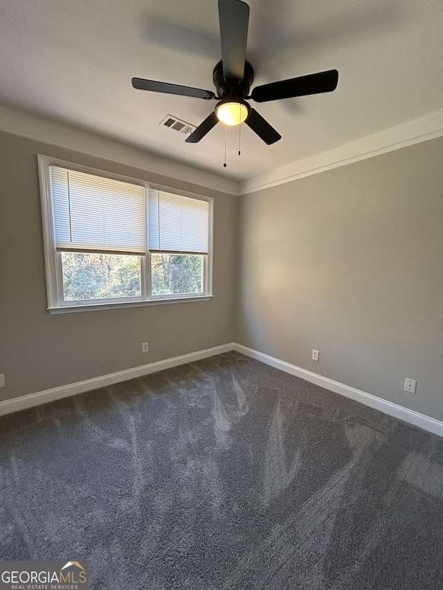 carpeted empty room with ceiling fan and ornamental molding