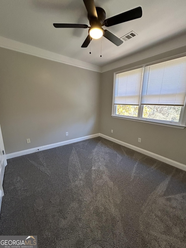 empty room featuring carpet flooring, ceiling fan, and ornamental molding