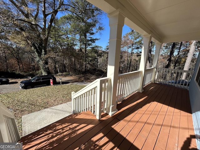 wooden terrace featuring covered porch