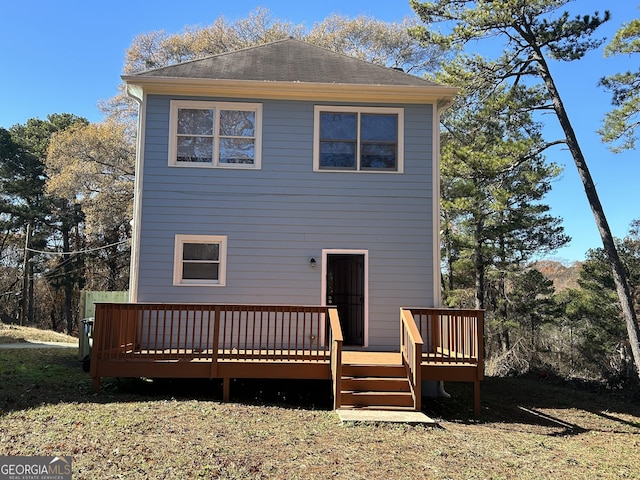 rear view of house featuring a deck