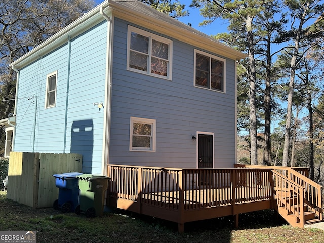 rear view of house featuring a wooden deck