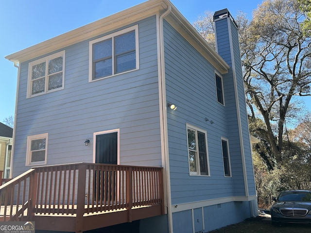 back of property featuring a deck