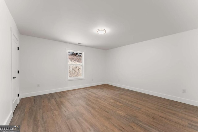 unfurnished room featuring dark wood-type flooring