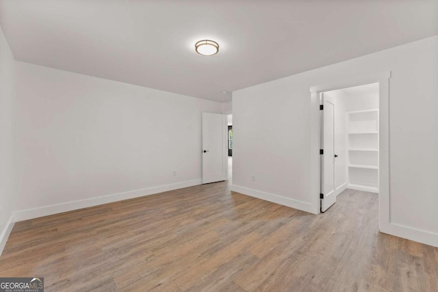 spare room featuring light wood-type flooring