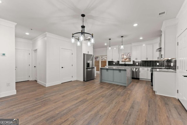 kitchen with stainless steel appliances, dark wood-type flooring, decorative light fixtures, white cabinets, and a center island