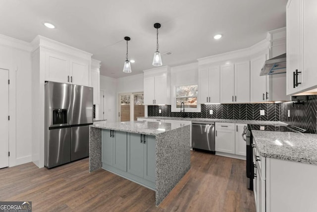 kitchen with white cabinetry, dark wood-type flooring, pendant lighting, a kitchen island, and appliances with stainless steel finishes